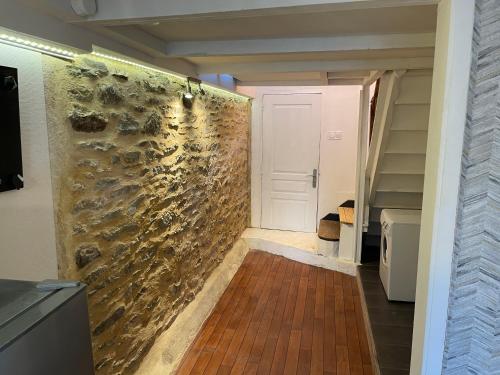 a hallway with a stone wall in a house at Studio 42m2 centre-bourg in Saint Hernin