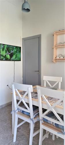 a dining room with a table and two chairs at Traditional house in the heart of Naxos in Dhamariónas