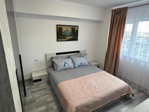 a bedroom with a large bed with blue pillows at 1 Mai - Luxury Park Apartments - Self Check-in - Private parking - 1 in Craiova