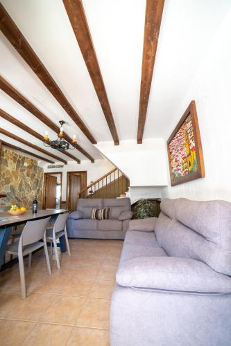 a living room with a couch and a table at Casas Rurales Los Olivos in Alcalá del Júcar