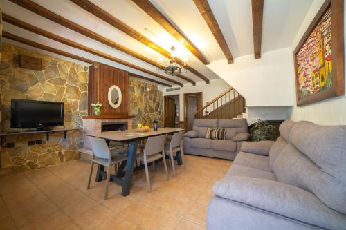 a living room with a couch and a table at Casas Rurales Los Olivos in Alcalá del Júcar