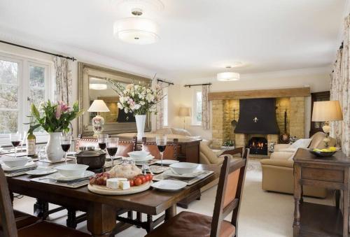 a dining room with a table and a living room at Chipping Campden - Cotswolds private house with garden in Chipping Campden