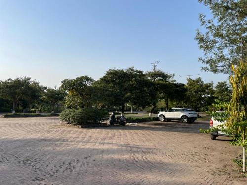 a parking lot with two cars parked in it at Hotel Sarai Bharatgarh in Chandīgarh