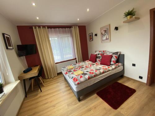 a bedroom with a bed and a table in it at Gospodarstwo Agroturystyczne Zasadkowe Bory in Rogowo