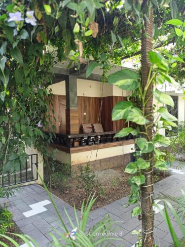 a bench in the middle of a garden at Leaf Garden Retreat in Varkala