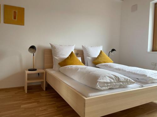 two beds with pillows on them in a room at Gamsfels Josephine Galeriewohnung in Langen bei Bregenz