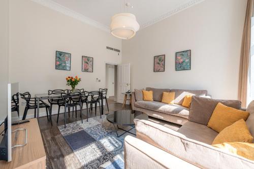 a living room with a couch and a dining room at Manson Place in London