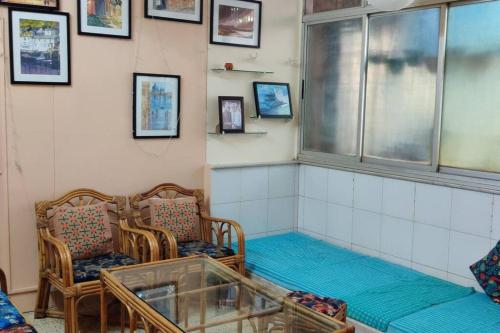 a waiting room with chairs and a window at Secluded & green 2BHK in ancestral bunglow SCruz E in Mumbai