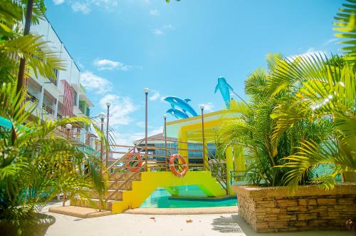 a playground with a slide in front of a building at Moalboal Tropics in Moalboal