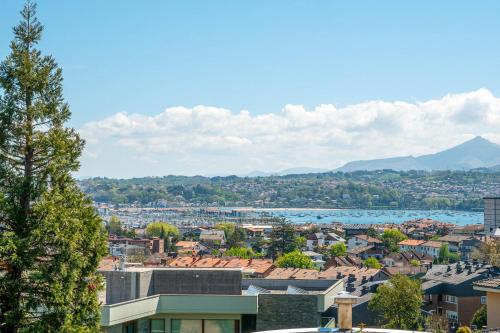 a city with a lake and mountains in the background at Bista Eder Hotel & Lodge in Hondarribia