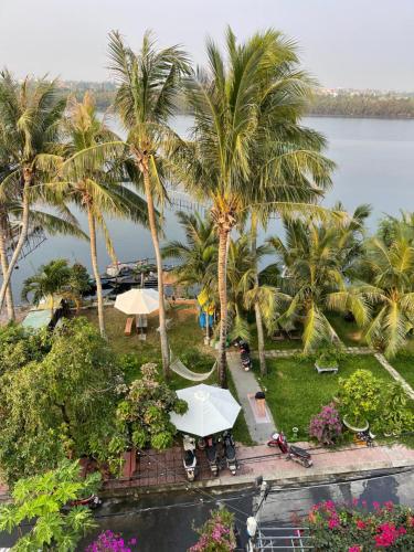 an aerial view of a resort with palm trees at Coral Riverside Homestay & Hostel in Hoi An