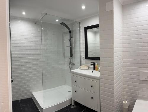 a white bathroom with a shower and a sink at Accommodation in Sesimbra - Two Double Bedroom in Sesimbra