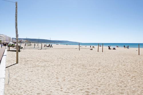 a beach with a bunch of people on it at Apartamento Atlántico in Barbate