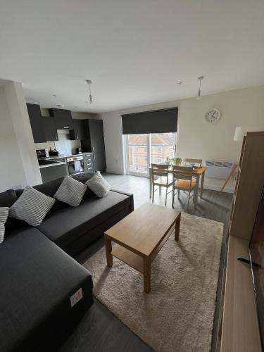 a living room with a couch and a table at 2 Bedroom City Centre Apartment in Hemel Hempstead in Hemel Hempstead
