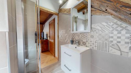 a bathroom with a toilet and a sink and a shower at Les Appartements Manala - Turckheim in Turckheim