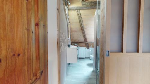 a room with a hallway with a sink and a door at Les Appartements Manala - Turckheim in Turckheim