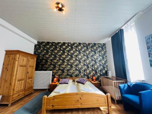 a bedroom with a bed and a blue couch at Hotel My My in Lahnstein