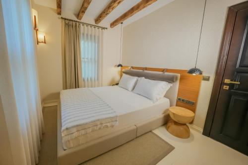 a small bedroom with a bed and a window at Nuup Hotel in Marmaris