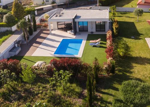 an aerial view of a house with a swimming pool at Meirinha House in Viana do Castelo