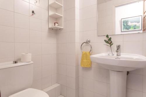 une salle de bains blanche avec toilettes et lavabo dans l'établissement Bonaire, à L'Escala
