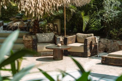 a patio with a couch and a table at Hotel Can Sastre in Santa Gertrudis de Fruitera