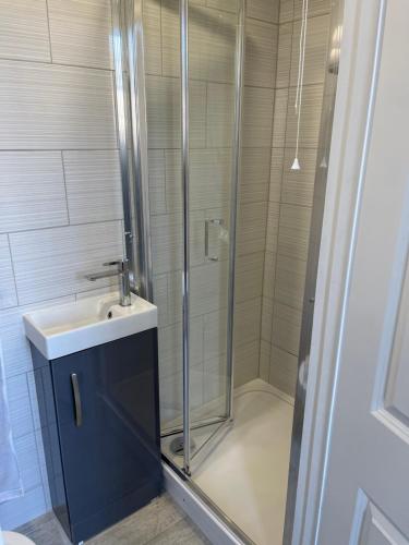 a bathroom with a shower and a sink and a shower at Cosy Studio With Full Facilities. in London