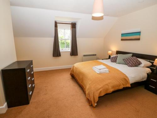 a bedroom with a large bed and a window at No 3 an Seanachai in Dungarvan