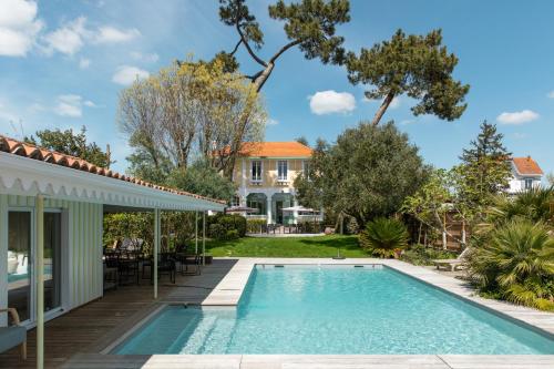 a swimming pool in the backyard of a house at Villa Les Délices in Cap-Ferret