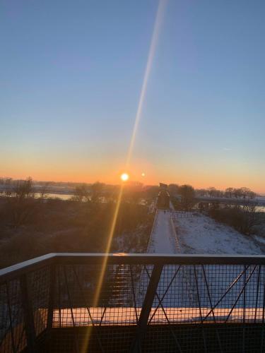 a view of the sunset from the balcony of a house at Noclegi Little Sheep in Chojna