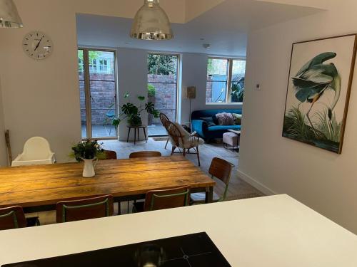 a living room with a wooden table and chairs at Ideal Bristol getaway - 3 bed harbourside home in Bristol