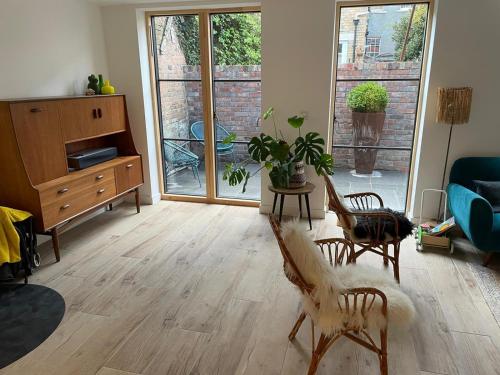 a living room with a couch and a table with chairs at Ideal Bristol getaway - 3 bed harbourside home in Bristol