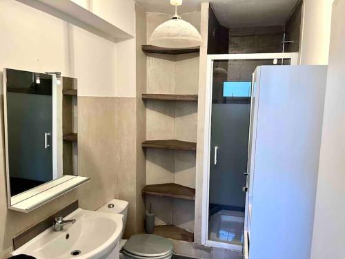 a bathroom with a sink and a toilet and a mirror at Studio résidence de Standing Piscine proche plage in Antibes