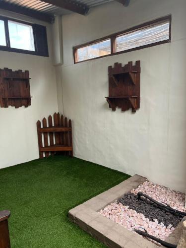 a room with green grass and two chairs and windows at Kuruman Hotel in Kuruman