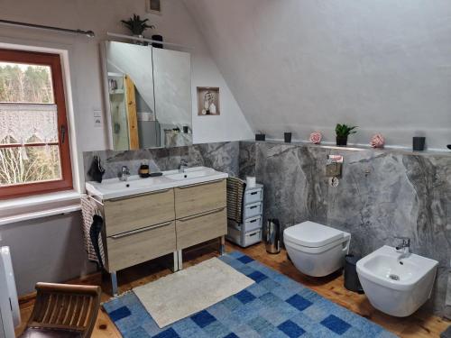 a bathroom with a sink and a toilet at Domek letniskowy Wczasy nad morzem in Sasino