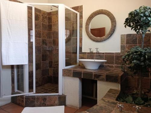 a bathroom with a sink and a shower at Kuruman Hotel in Kuruman