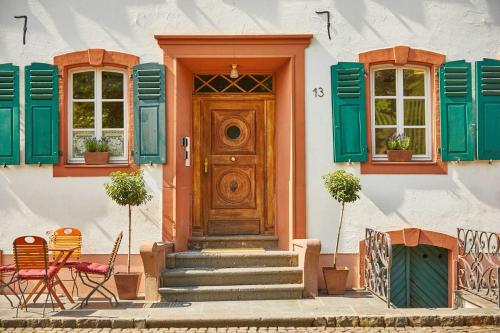 a house with green shutters and a wooden door at NEU!!! Moselbleibe Uferallee in Bernkastel-Kues