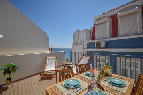 a patio with a table and chairs on a balcony at Central & Stylish 2 Bedroom Apartment w/ Balcony in Cascais