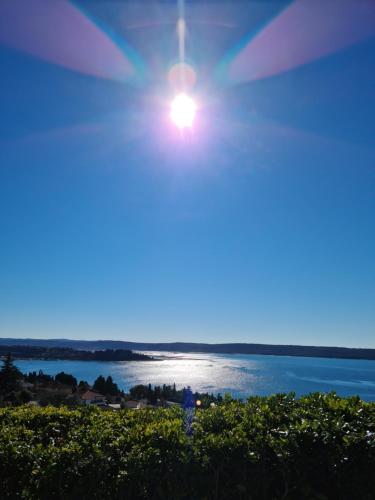 a view of the ocean from the beach at dusk at Apartments Vila Toni in Portorož