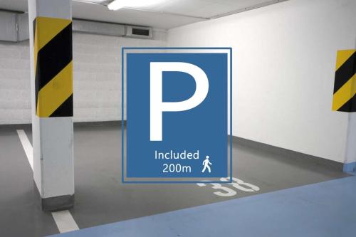 a parking sign in a parking garage with a person walking around it at Entre Ruas Apartments in Coimbra