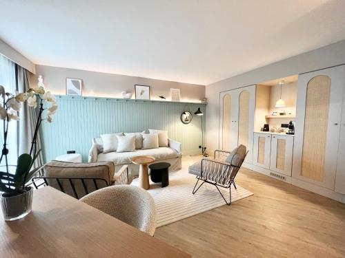 a living room with a couch and a table at Emeria Dinard Thalasso Spa in Dinard