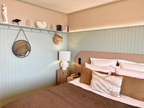 a bedroom with a bed with a mirror on the wall at Emeria Dinard Thalasso Spa in Dinard