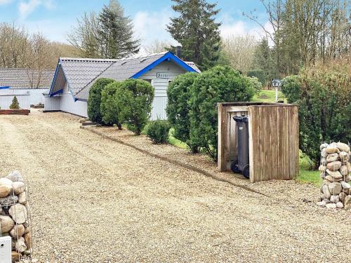 a house with a shed and a gravel driveway at 6 person holiday home in Ansager in Ansager