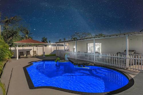 a house with a blue swimming pool at night at Modern Villa with Pool Hollywood Hard Rock Casino in Fort Lauderdale