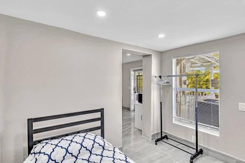 a white bedroom with a bed and a window at Modern Villa with Pool Hollywood Hard Rock Casino in Fort Lauderdale