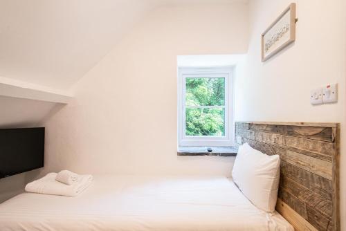 a bedroom with two beds and a window at Tregenna Castle Resort in St Ives