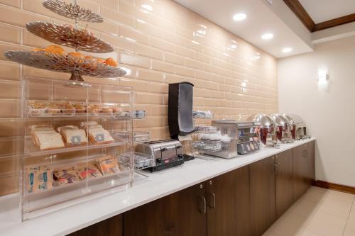 a kitchen with a counter with food on it at Econo Lodge Inn & Suites Foley-North Gulf Shores in Foley