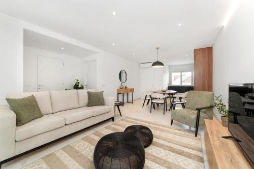 a living room with a couch and a table at Caminho Real S - By SCH in Nazaré