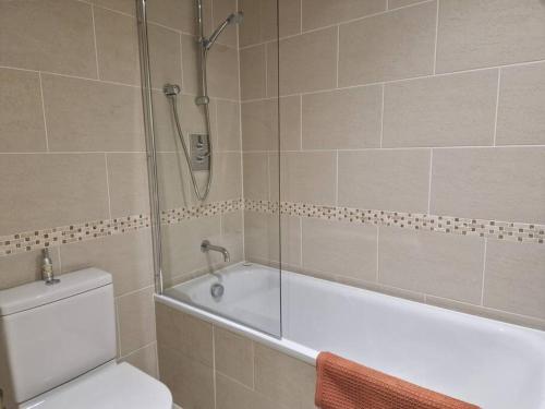 a bathroom with a tub and a toilet and a shower at Lovely London on a budget! in London