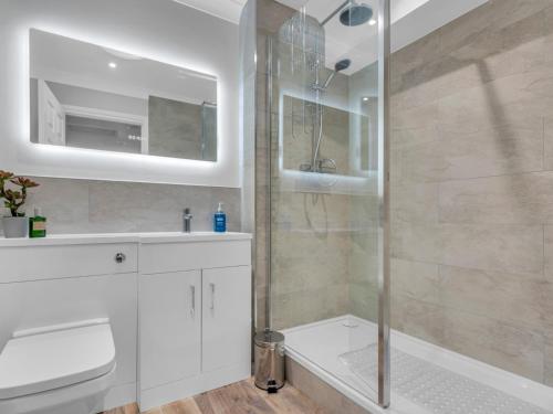 a white bathroom with a shower and a sink at Pass the Keys Stunning 2 Bed House by the Sea in Whitstable