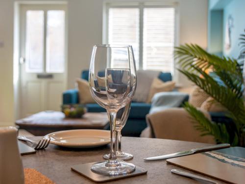 a wine glass sitting on top of a table at Pass the Keys Stunning 2 Bed House by the Sea in Whitstable
